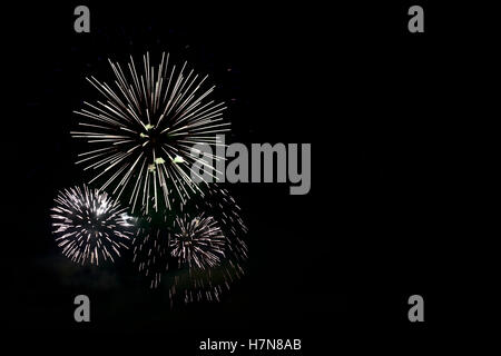Colorful celebration fireworks isolated on black background. Stock Photo