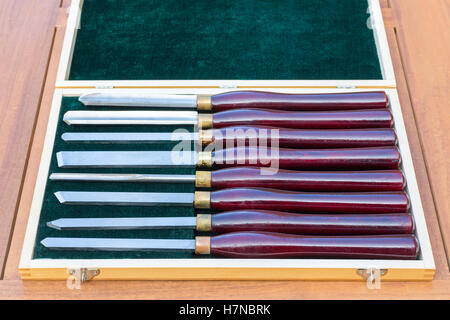 Set of almost new wood turning chisels in wooden box on table Stock Photo