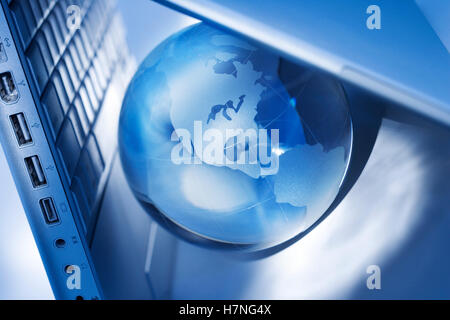 glass globe and laptop Stock Photo