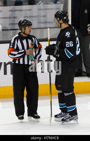 Feb 10, 2012; San Jose, CA, USA; San Jose Sharks center Michal Handzus (26) talks with NHL referee Brian Pochmara (16) during a stoppage in play against the Chicago Blackhawks during the first period at HP Pavilion. San Jose defeated Chicago 5-3. Stock Photo
