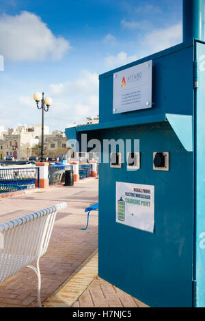 Malta, Pretty Bay. Charging point provided free by Attard company for electric wheelchairs and mobile phones. Stock Photo