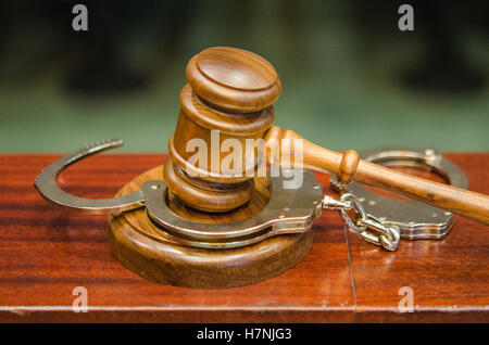 Criminal Law, gavel and handcuffs in courtroom Stock Photo