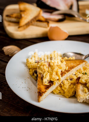 Traditional breakfast scrambled eggs with bacon and onion Stock Photo