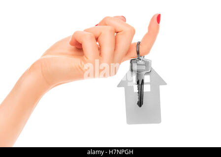 Hand holds key with a keychain the shape of house. Stock Photo