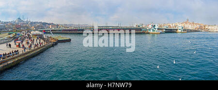 The panoramic view from the ferry on the wide Golden Horn Bay, Eminonu promenade and Galata bridge Stock Photo