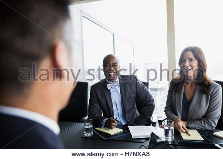 Smiling business people talking in conference room meeting