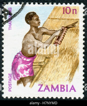 ZAMBIA - CIRCA 1981: A stamp printed in Zambia, is dedicated to Cultural Heritage, shows a Thatching, circa 1981 Stock Photo