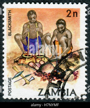 ZAMBIA - CIRCA 1981: A stamp printed in Zambia, is dedicated to Cultural Heritage, shows a Blacksmith, circa 1981 Stock Photo