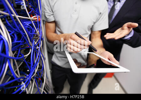 Men with tablet in data storage service room close up Stock Photo