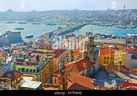 The roofs of the old neighborhoods and the Galata bridge in the light morning haze, view from Galata Tower, Istanbul, Turkey. Stock Photo
