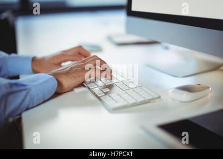 Hand of businessman using desktop pc Stock Photo