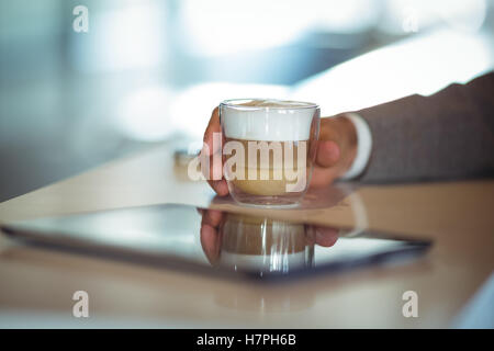 Businessmans hand holding coffee cup Stock Photo