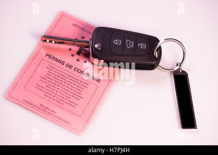 Car keys and drivers license on white background, France Stock Photo