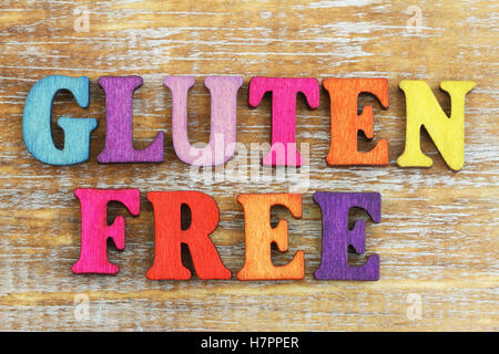 Gluten free written with colorful letters on rustic surface Stock Photo