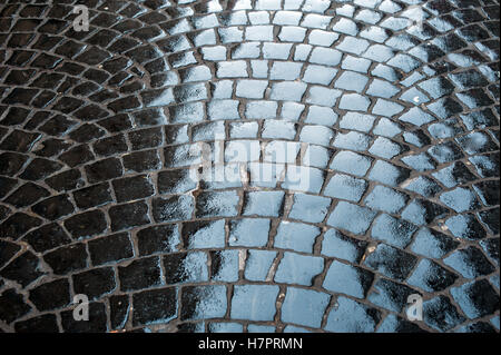 Old Rough texture of wet stones pavement Stock Photo