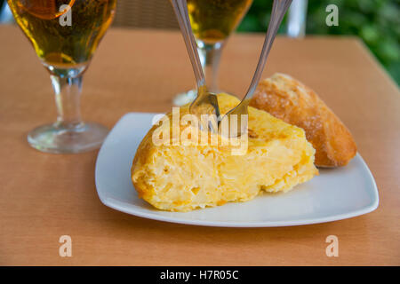 Spanish tapa: pincho de tortilla, Spanish omelet in a terrace. Close view. Stock Photo