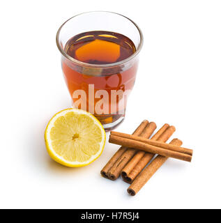 Tea in glass cup, lemon and cinnamon sticks isolated on white background. Stock Photo