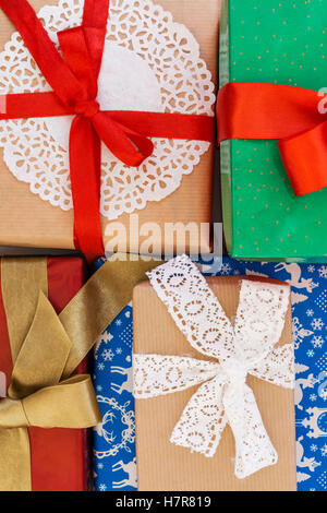 Pile of Christmas wrapped presents with twine string roll, fir tree branch,  Christmas toy star at wooden background. Xmas decoration, cozy festive  Stock Photo - Alamy
