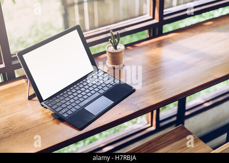 Laptop with blank screen on table,Responsive design mockup,Corporate identity mock up on desk with laptop computer,smart phone,c Stock Photo