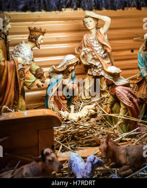 Christmas Manger scene with figurines including Jesus, Mary, Joseph, sheep and magi Stock Photo