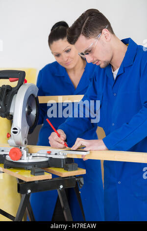 student in carpentry class using circular saw Stock Photo