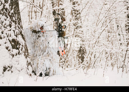 Bowhunter In Snow Ghillie Suit Stock Photo