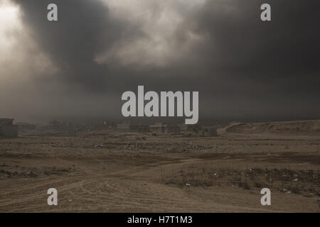 Qayyarah, Niniveh, Iraq. 8th Nov, 2016. 08/11/2016. Qayyarah, Iraq. A sooty smog fills the air over the town of Qayyarah, Iraq. Oil wells in and around the town of Qayyarah, Iraq, we set alight in July 2016 by Islamic State extremists as the Iraqi military began an offensive to liberated the town.For two months the residents of the town have lived under an almost constant smoke cloud, the only respite coming when the wind changes. Credit:  ZUMA Press, Inc./Alamy Live News Stock Photo