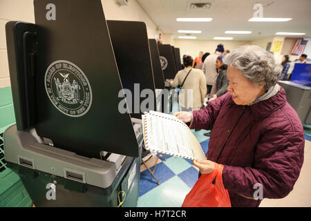 New York, USA. 8th Nov, 2016. A Chinese-American voter casts her ballot at a polling station in Queens, New York, the United States, Nov. 8, 2016. The U.S. presidential elections kicked off on Tuesday. Credit:  Wang Ying/Xinhua/Alamy Live News Stock Photo