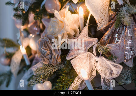 Christmas ornaments are decorations usually made of glass, metal, wood or ceramics that used to festoon a tree. Blurred gifts on background. Stock Photo