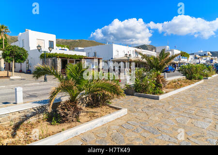 PAROS ISLAND, GREECE - MAY 17, 2016: street with palm trees and white houses in Parikia town on Paros island, Greece. Stock Photo