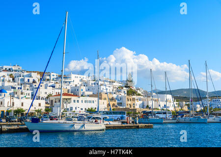 NAOUSSA TOWN, PAROS ISLAND - MAY 17, 2016: white houses of Naoussa town and sailing boats on island of Paros, Greece. Stock Photo