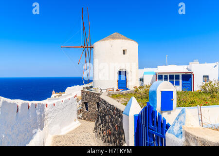 Typical white windmill on street of Oia village, Santorini island, Greece Stock Photo