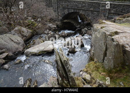 Quaint old Drovers road packhorse bridge hidden under A5 bridge Pont Pen-y-benglog above Ogwen falls Snowdonia Wales UK Stock Photo