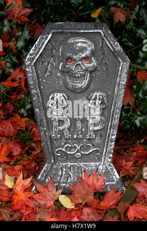Halloween tombstone decorated with skulls and rest in peace RIP lettering, Vancouver, BC, Canada Stock Photo