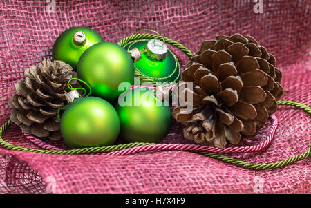 Christmas setting with green decoration on pink textile Stock Photo
