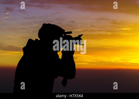 Silhouette of Photographer on Hilltop in beautiful clouds Stock Photo ...