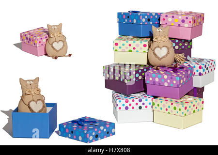 Gift boxes.A set of gift boxes with toys on a white background .. The cat toy lies in an open box. Stock Photo