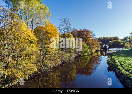 Autumn in Pollok Park Glasgow Scotland with White Cart Water and weir with old mill Stock Photo