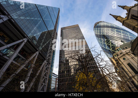 LONDON - NOVEMBER 3, 2016: The Cheesegrater and The Gherkin skyscrapers stand above the 16th century St Andrew Undershaft church Stock Photo