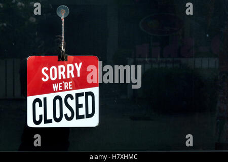 Closed sign in a shop window sorr we are closed. Stock Photo