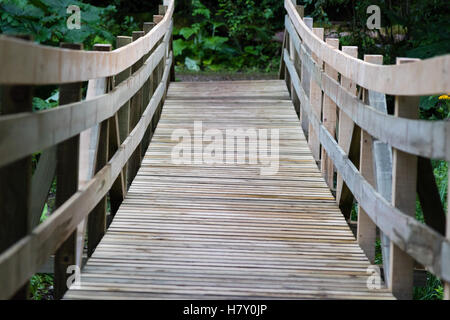 old wooden bridge walkway outdoors in forest Stock Photo