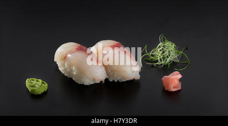 sushi nigiri decorated with wasabi and seaweed salad Stock Photo