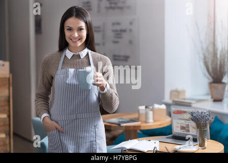 Pretty young woman drinking coffee Stock Photo