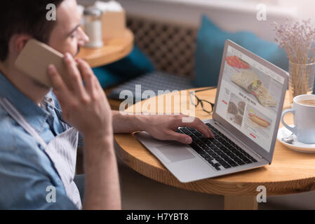 Close up of handsome young man using laptop Stock Photo