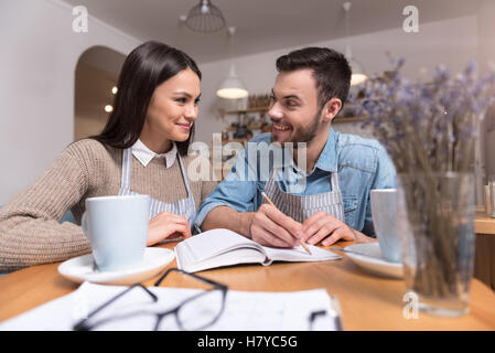 Satisfied young couple making notes Stock Photo