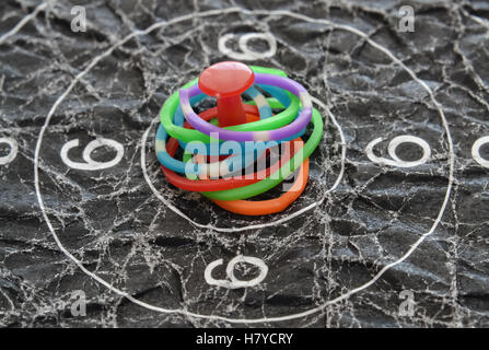 Closeup of colorful rings and red pin in the center of the target Stock Photo