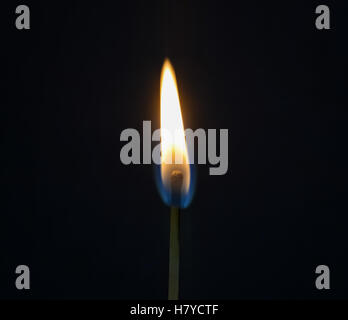 Closeup of a burning safety match on dark background Stock Photo