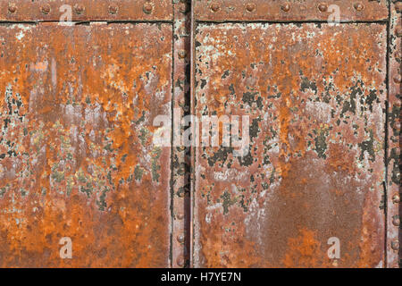 A rusty metal surface with structural joints and rivets. Stock Photo
