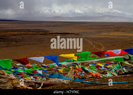 Colorful prayer flags,  Mt. Gurla Mandhata,  7728m, and the sacred Manasarovar Lake. Tibet, China. Stock Photo