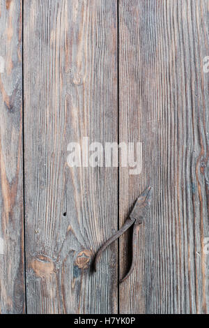 Old rusty steel pliers on wooden background Stock Photo